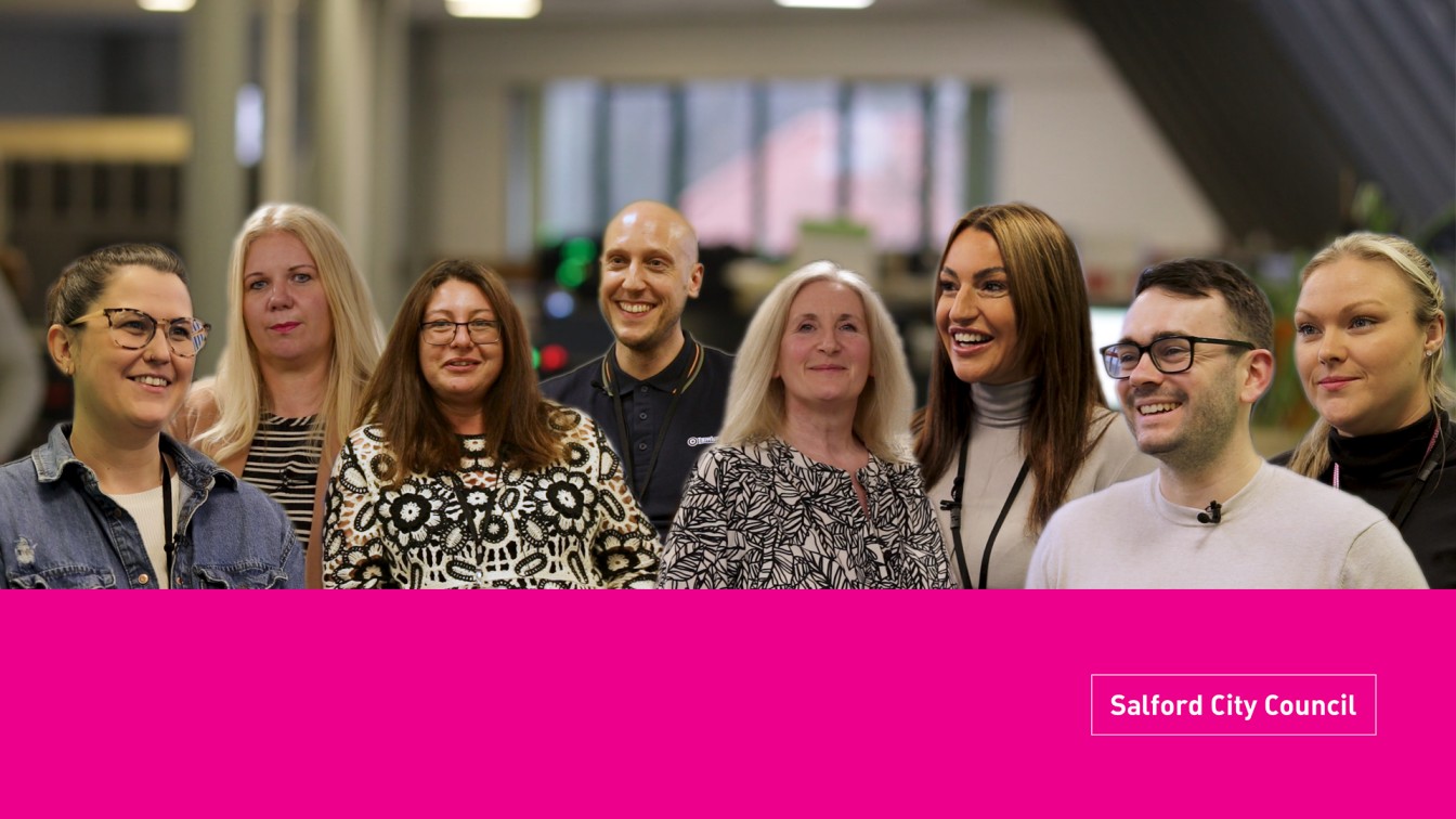 Group of smiling people from Salford City Council.