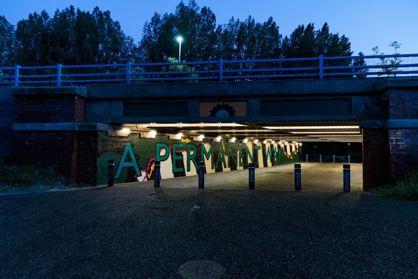 Tunnel with "A Permanent Way" graffiti.