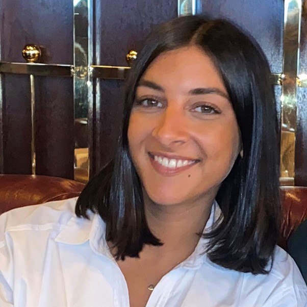 Woman with dark hair and white shirt.