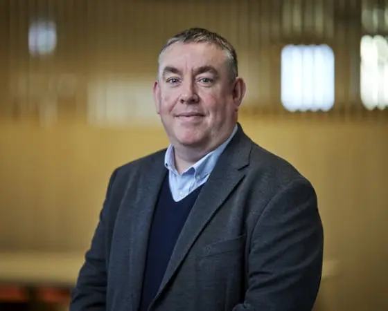 Man in a suit looking at the camera.