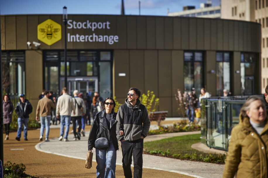 People walking outside of the Stockport Interchange.