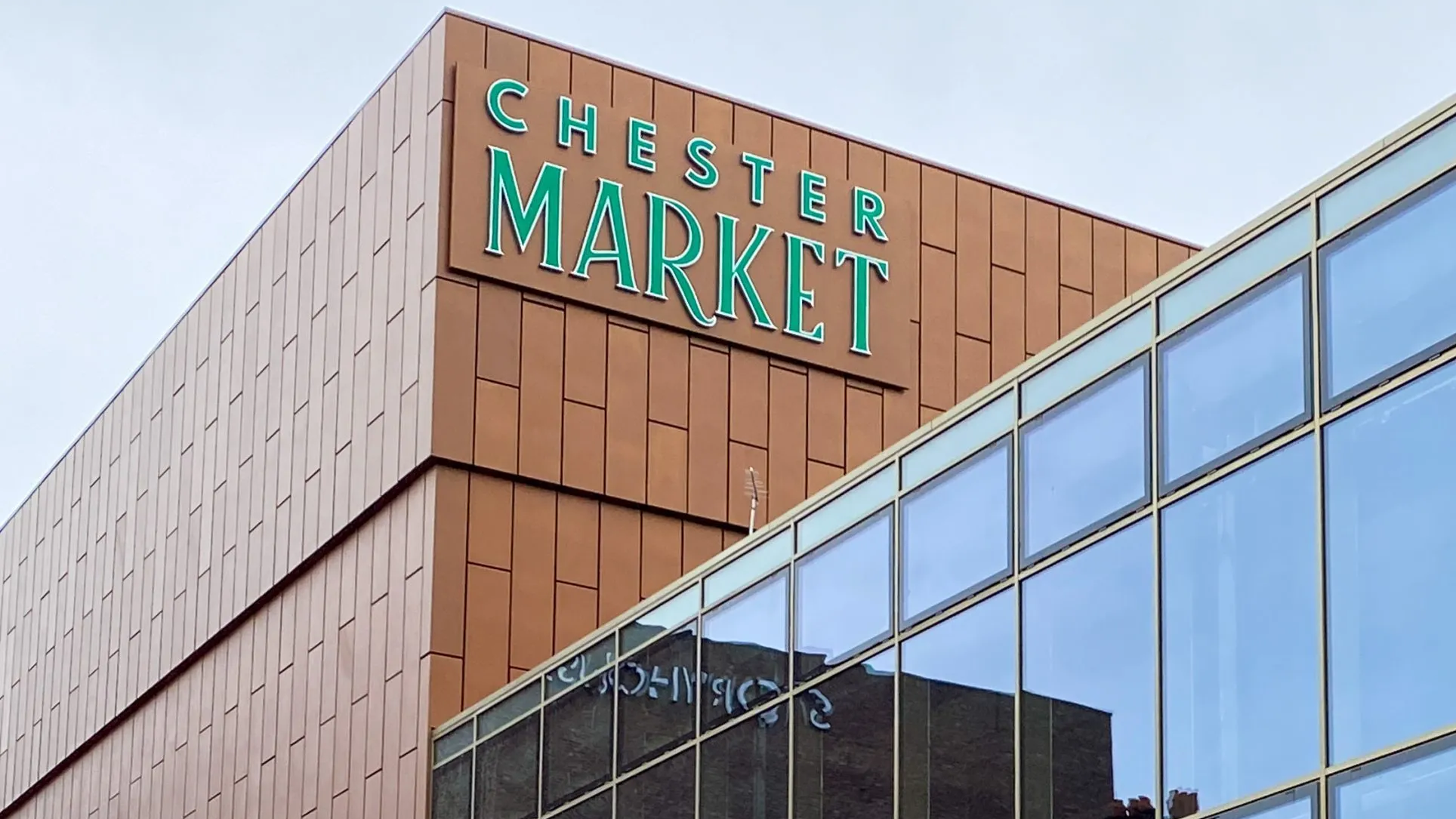 Exterior view of the Chester Market building with a glass facade.