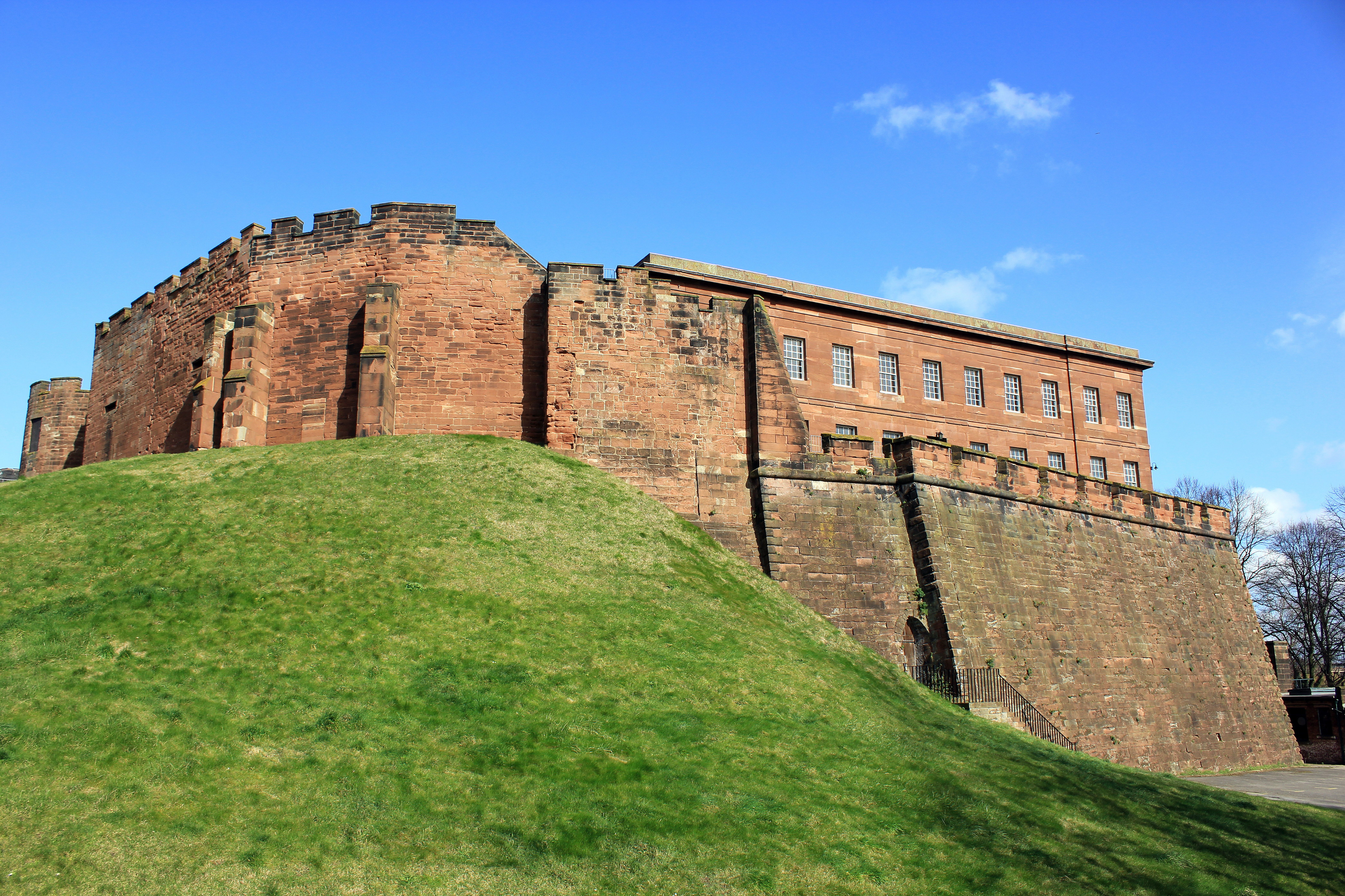 Historic castle on a hill with a blue sky.