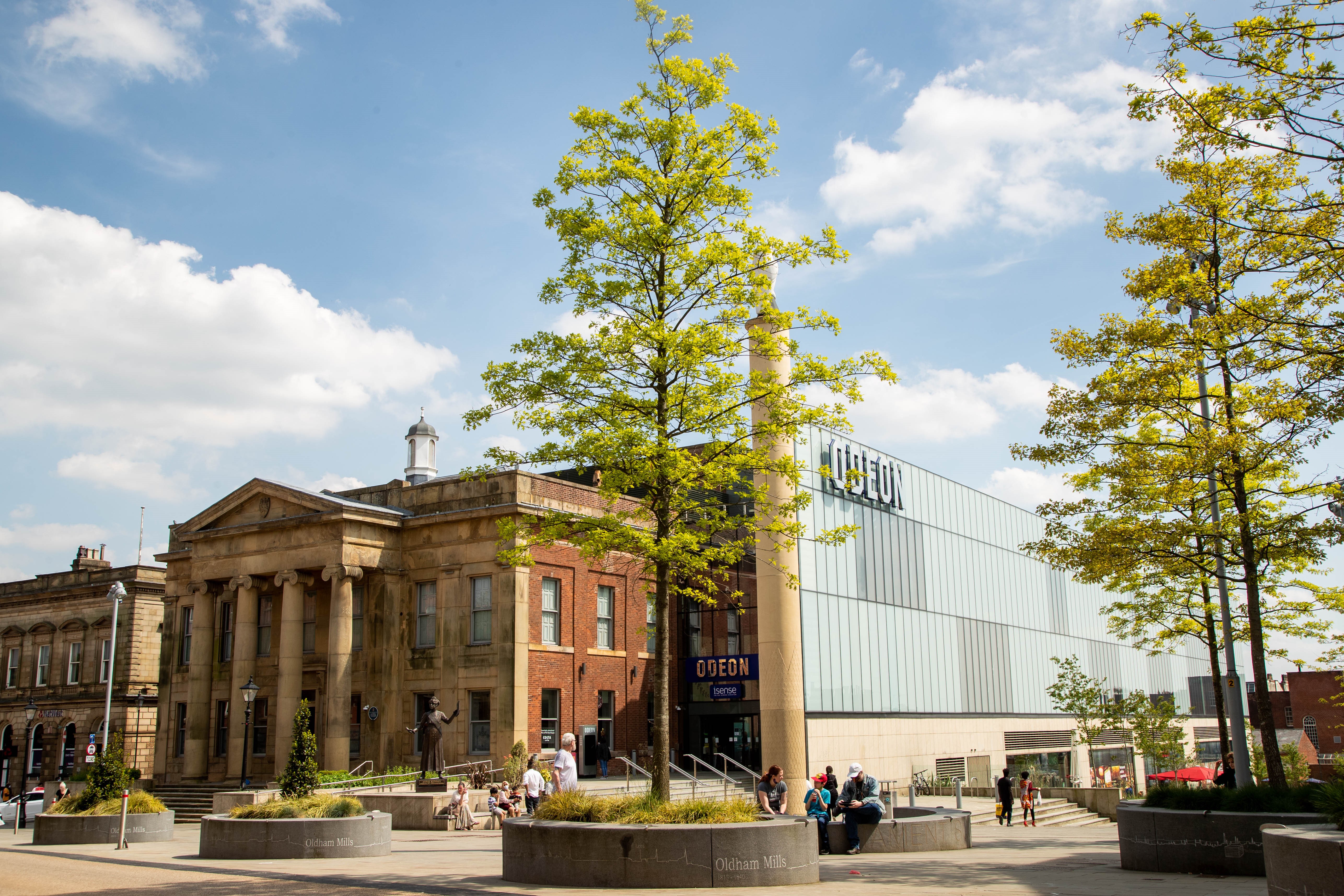 Buildings and trees in a park on a sunny day.