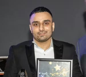 Man holds awards for Top Awards 2019, Winner.