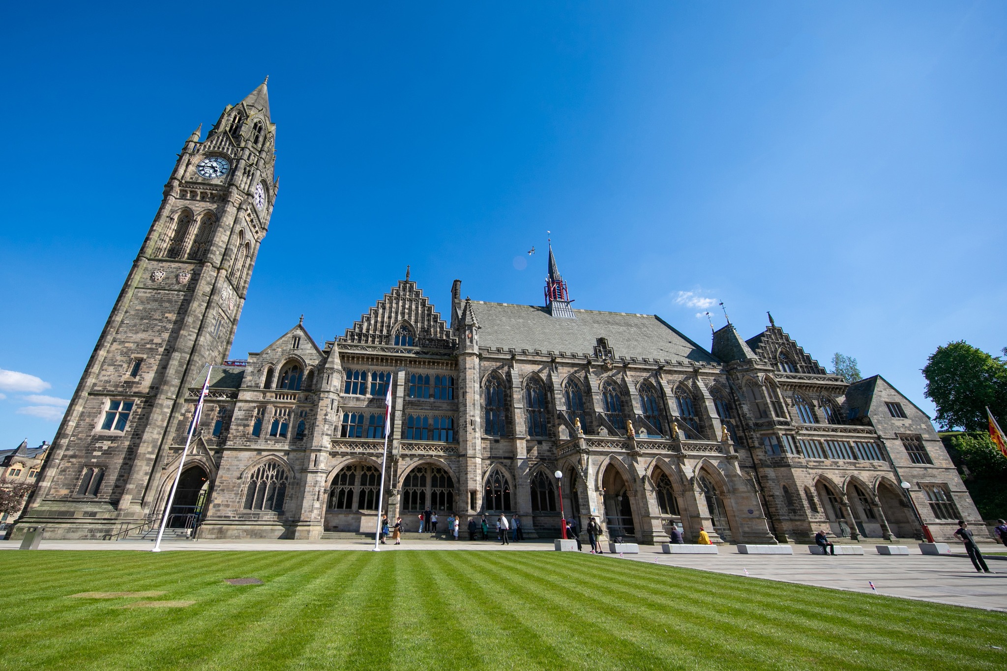 Town Hall building with clock tower, sunny day, blue sky.