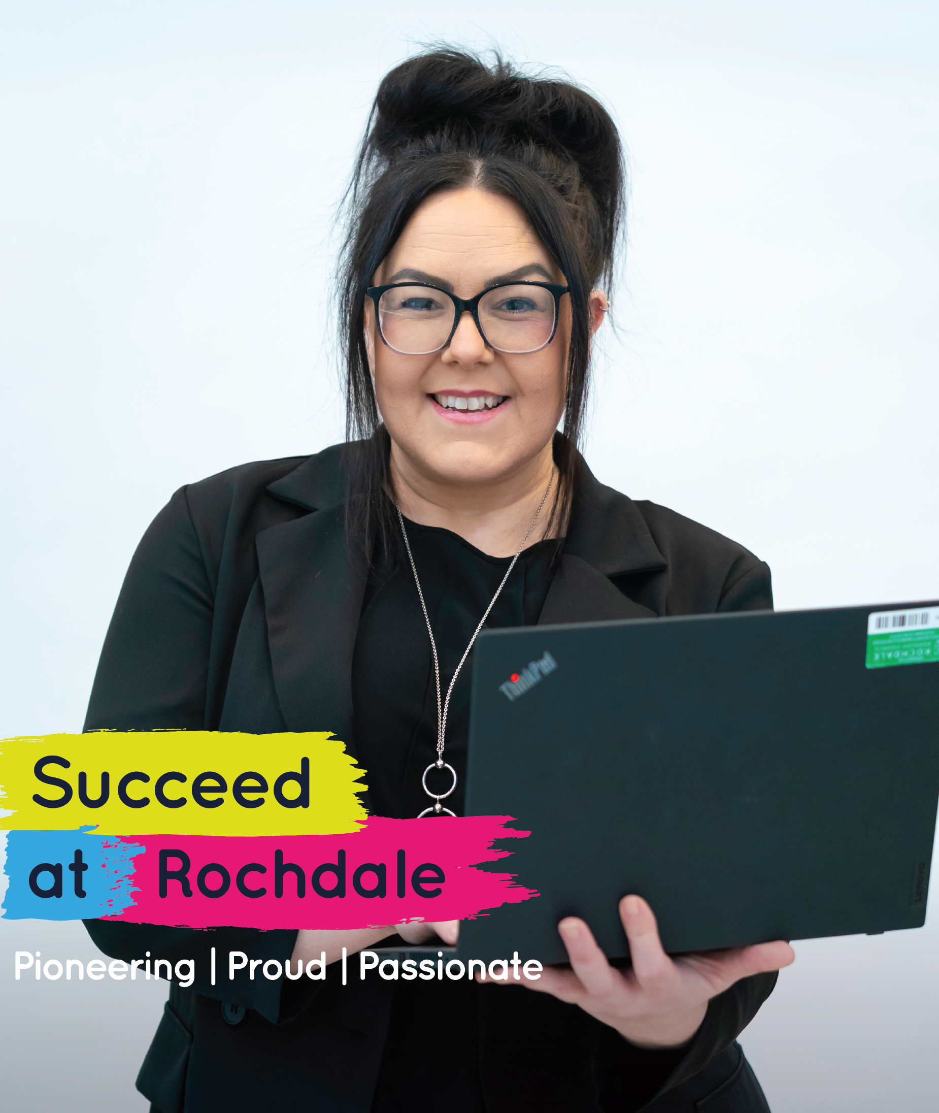 A woman with glasses and her hair in a bun smiles while holding a laptop. Text reads "Succeed at Rochdale" and "Pioneering